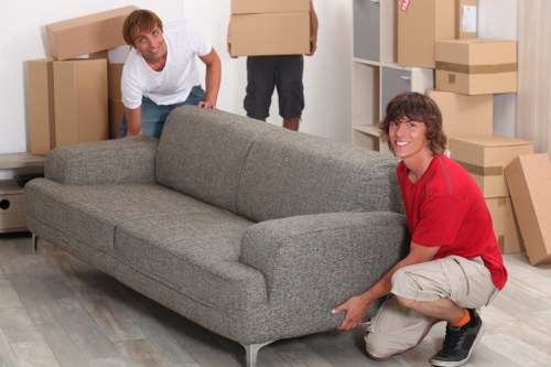Removal professionals loading furniture on moving day