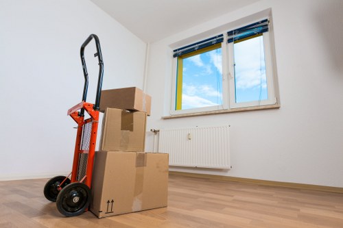 Efficient flat removals in Lamorbey with movers preparing furniture for transport